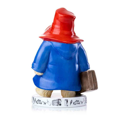 A slightly angled rear view captures the overlapping details of Paddington's coat, hat, and suitcase, offering a full perspective of the figurine's artistry.