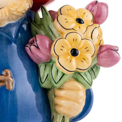 Paddington’s bouquet is seen in exquisite detail, with vivid colours and delicate design, emphasizing the artistry and care in this handmade figurine.