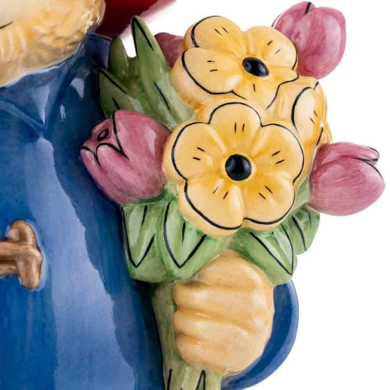 Paddington’s bouquet is seen in exquisite detail, with vivid colours and delicate design, emphasizing the artistry and care in this handmade figurine.