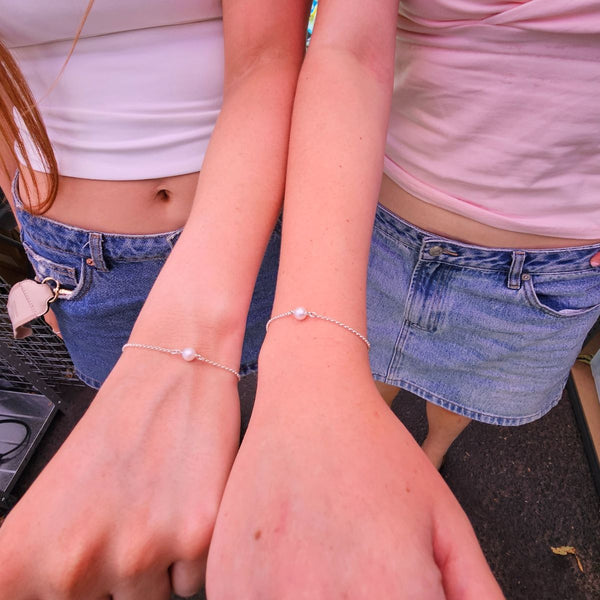 Two Customers wearing Permanent Bracelets with Pearls - Tamworth Permanent Jewellery with Charms by Jewels of St Leon.
