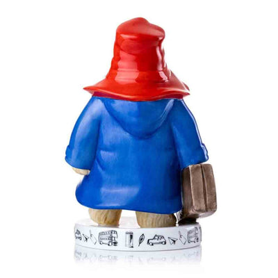 Paddington's red hat and flowing blue coat are showcased from the back, with intricate sculpting and realistic folds. The suitcase handle is visible, adding to the lifelike design.