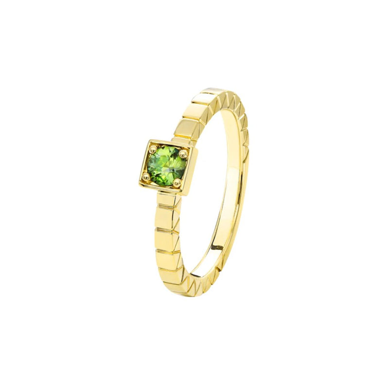 A detailed front view of the Quinn Ring, highlighting the 3mm green sapphire set in luxurious 9kt yellow gold. The unique square setting showcases the sapphire&