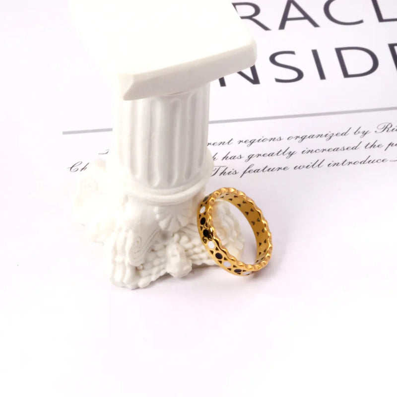 Papel Picado band in 18K gold-plated stainless steel with cut-out hearts and black & white enamel. A unique, European-style stackable ring with regal charm.