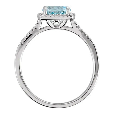 A front view of the Sky Blue Topaz and Diamond Halo Style Birthstone Ring, featuring the radiant 7mm topaz and the delicate beaded halo with diamond accents, set in gleaming rhodium-plated sterling silver.