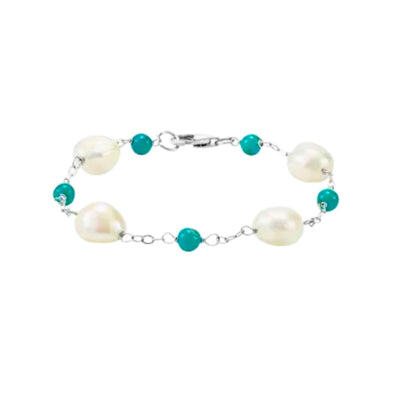 A beautiful Sterling Silver Cultured White Pearl and Natural Turquoise Station Bracelet. This exquisite piece is a perfect addition to your silver jewellery collection. This modern station bracelet features four 10-11mm cultured white pearls and five 5mm natural turquoise gemstones set in a beautiful silver chain. Shop now at Jewels of St Leon.