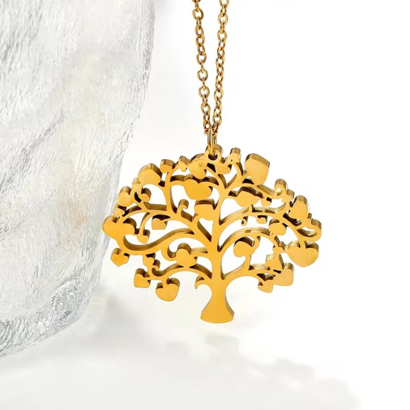 Close-up of the Tree of Life pendant, revealing the delicate network of tiny hearts that form the golden tree in stunning 18K gold detail.