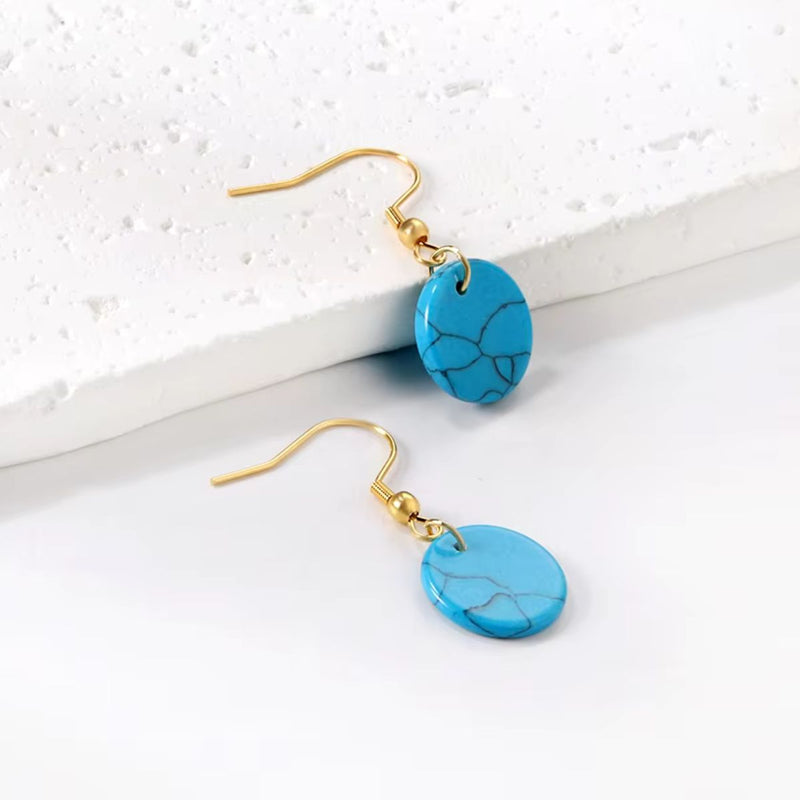 A vibrant close-up of the Turquoise Style Earrings, showcasing their bright turquoise-inspired design and gleaming 18K gold-plated accents.