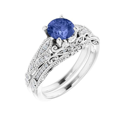 14K White Gold Tanzanite and Diamond Vintage Inspired Engagement Ring, set with a 1.15ct Natural AAA Grade Tanzanite Gemstone with Diamond Accents to highlight the vintage pattern on the band with matching contoured and accented wedding band. Available from Jewels of St Leon Bridal Jewellery Australia.