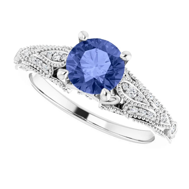 14K White Gold Tanzanite and Diamond Vintage Inspired Engagement Ring, set with a 1.15ct Natural AAA Grade Tanzanite Gemstone with Diamond Accents to highlight the vintage pattern on the band. Available from Jewels of St Leon Bridal Jewellery Australia.