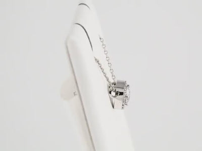 Video - This stunning ladies' necklace is a part of our exquisite diamond jewellery collection. It features a 0.33ct centre diamond, which is surrounded by 16 diamond accents, all set in a halo-style design. The centre diamond is 4.3mm in size, and the pendant measures 7.2mm in diameter. The necklace is made of rhodium-plated 14K white gold and comes with a 40cm chain length. Available from Jewels of St Leon Online Gold Jewellery Australia.