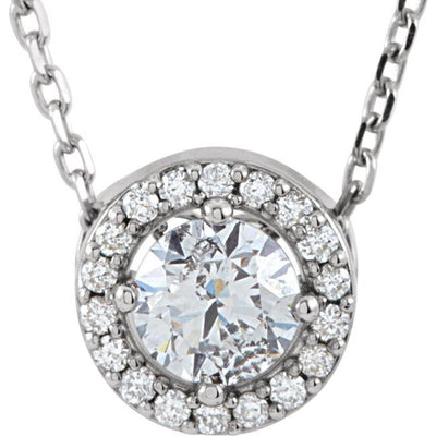 This stunning ladies' necklace is a part of our exquisite diamond jewellery collection. It features a 0.33ct centre diamond, which is surrounded by 16 diamond accents, all set in a halo-style design. The centre diamond is 4.3mm in size, and the pendant measures 7.2mm in diameter. The necklace is made of rhodium-plated 14K white gold and comes with a 40cm chain length. Available from Jewels of St Leon Online Jewellery Australia.