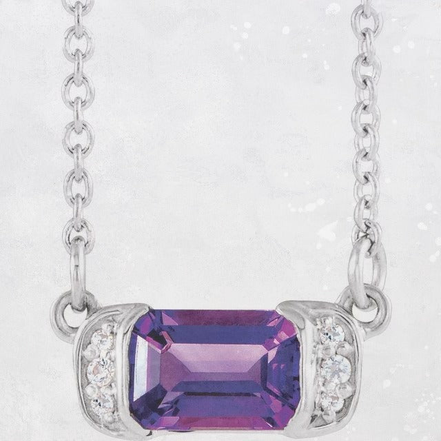 Elevate your style with this stunning Amethyst and Diamond Bar Necklace, crafted in high-quality sterling silver. The centrepiece of this necklace is an elegant 5.48x11.65mm bar pendant featuring a sparkling emerald-cut 6x4mm Amethyst gemstone in the centre, surrounded by six dazzling 0.02ctw diamonds on either side. The pendant hangs from a 40cm length chain, making this necklace the perfect fit for any occasion. Available from Jewels of St Leon Online Jewellery Australia.